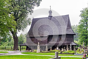 View at the Wooden Church of Saint Leonard at Cemetery of Lipnica Murowana in Poland photo
