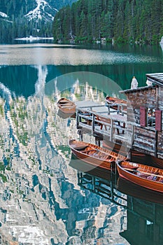 view of wooden dock boats station at braies lake in Italy