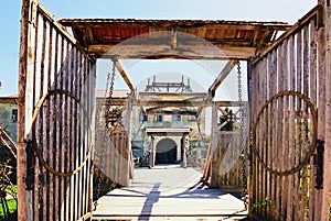 View of wooden drawbridge and main Gate of the Zolochiv Castle. Sunny spring day.