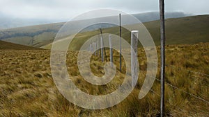 View of a wooden fence with razor wire in the moors in the area near the village of Checa