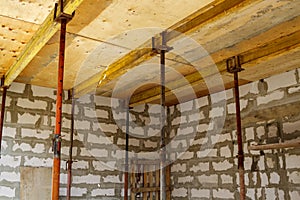 view of the wooden formwork with metal holders, which will be filled with the overlap between the floors in the country house