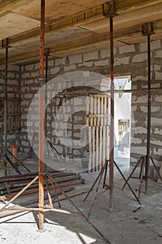 view of the wooden formwork with metal holders, which will be filled with the overlap between the floors in the country house