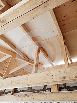 view of wooden rafters when installing roof on construction of house