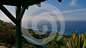 View from a wooden shed on Dans Gallas hiking trail, Mahe, Seychelles over northern coast with Silhouette Island and Ile du Nord.