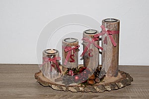 View on a wooden special advents wreath with one burning candle