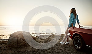 The view is always worth it. a young woman enjoying a road trip along the coast.