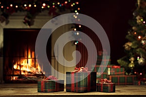 View of wrapped gifts and fireplace with christmas tree