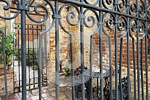 View through wrought iron gate garden sanctuary