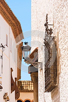 View of the wrought-iron grille and streetlight, Sitges, Barcelona, Catalunya, Spain. Vertical.