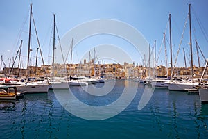 The view of yachts moored in harbor in Dockyard creek with Senglea peninsular on background. Malta