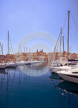 The view of yachts moored in harbor in Dockyard creek with Senglea peninsular on background. Malta