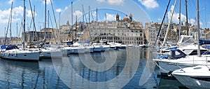 The view of yachts moored in harbor in Dockyard creek with Singlea peninsular on background. Malta