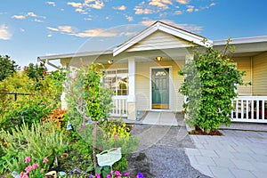 View of yellow covered porch with columns