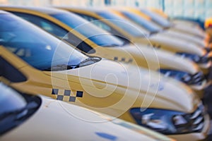 View of yellow taxi cab parking lot with yellow cars standing, set of taxicabs in the streets, taxis