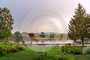 View of the Yenisei Bayou in Krasnoyarsk and the embankment, the design of the coastline. pine trees, greenery