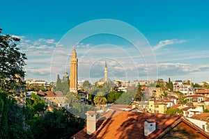 View of the Yivli Minaret among the houses in the old town of Kaleichi in the Turkish city of Antalya. photo