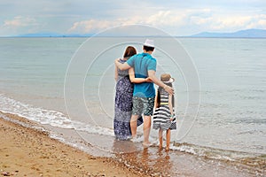 View of young family having fun on the beach