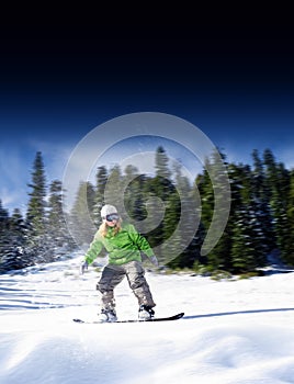 View of a young girl snowboarding in winter