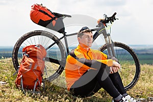 View of a Young Man With Bicycle on Summer Background.