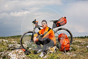 View of a Young Man With Bicycle on Summer Background.