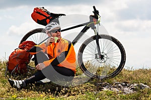 View of a Young Man With Bicycle on Summer Background.