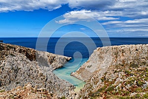 View of z-shaped bay, Crete landscape. Clear blue sky, great clouds, sunny day. Azure sea waters. Stefanou beach, Seitan