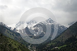 View of Zailiyskiy Alatau mountains in summer morning from Almaty Kazakhstan . Big Almaty Peak - famous landmark of city