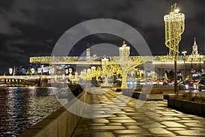 View of Zaryadye Park, soaring bridge over the Moscow river, the Kremlin and Pokrovsky Cathedral on new year and Christmas