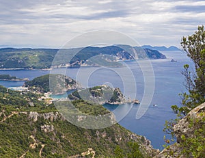 View at zigzag road, hills cllifs, forest and turquoise blue sea at Paleokastritsa bay from the view point at mediavel