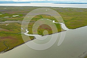 Rivers and inlets cut through the green and red tundra as they flow to the ocean in Alaska. photo
