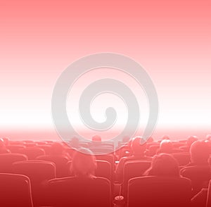 Viewers at movie theater, red toning copy space