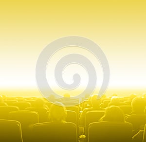 Viewers at movie theater, yellow toning copy space