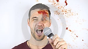 Viewers throw rotten tomatoes at a failed stand-up comedian. A young attractive guy gets hit in the face by a rotten
