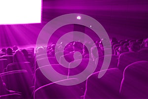 Viewers watch 3D movie, magenta toning