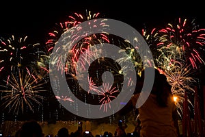 Viewers watch beautiful fireworks in the sky