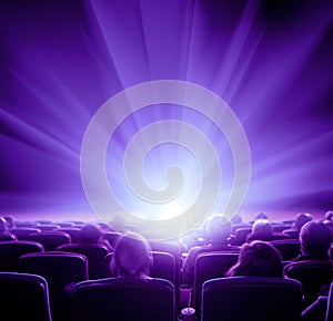 Viewers watch violet shining light in the cinema hall