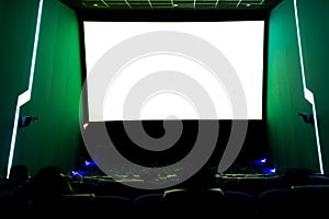 Viewers watching movie at cinema with screen isolated in white, long exposure