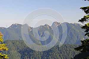 Viewing Mountains from Grouse Mountain with snow mountains in the distance