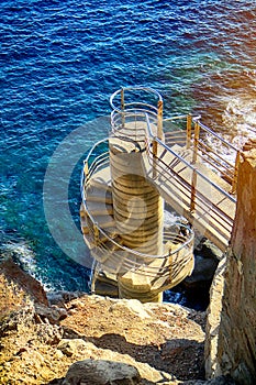 Viewing platform with spiral staircase to ocean shore, aerial view, seascape