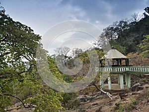 Viewpoint.Forest seen from viewpoint with cloudy sky, distant mountains in the background and forest in the foreground. Karnataka