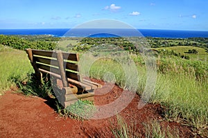 Viewpoint for Hanga Roa and Pacific Ocean with a Wooden Bench on Red Scoria at Puna Pau Volcano, Easter Island, Chile