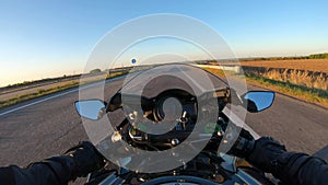 The viewpoint of motorcyclist driving motorbike at speed highway. Point of view of motorcycle rider rides fast in