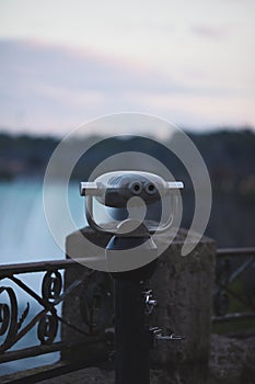 Viewpoint at Niagara Falls with a binocular in the foreground. Ontario, Canada