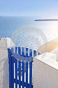 Views of the Aegean sea with blue gate in the foreground on Santorini island, Greece