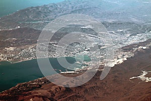 Views of bay and town on mountainous coast, aerial photography. Novorossiysk, Russia