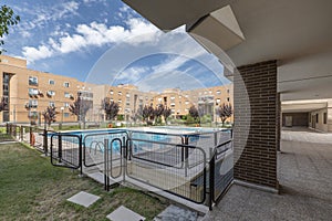 Views of buildings and common areas landscaped with flowers, grass, trees and summer pools of an urban residential development photo