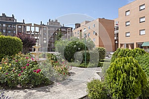 Views of buildings and common areas landscaped with flowers of an urban residential housing estate photo