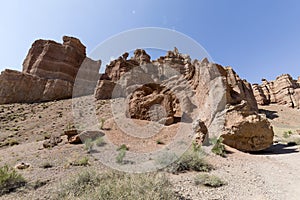 Views within the Charyn Canyon to the reddish sandstone cliffs. The canyon is also called valley of castles