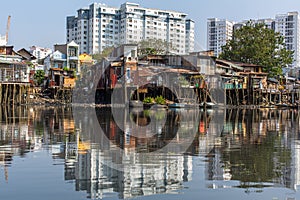 Views of the city's Slums from the river (in the background and in reflection of the new buildings)