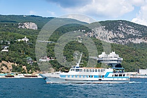 Views of the Crimean coastline with hotels and beaches with mountains in the background.